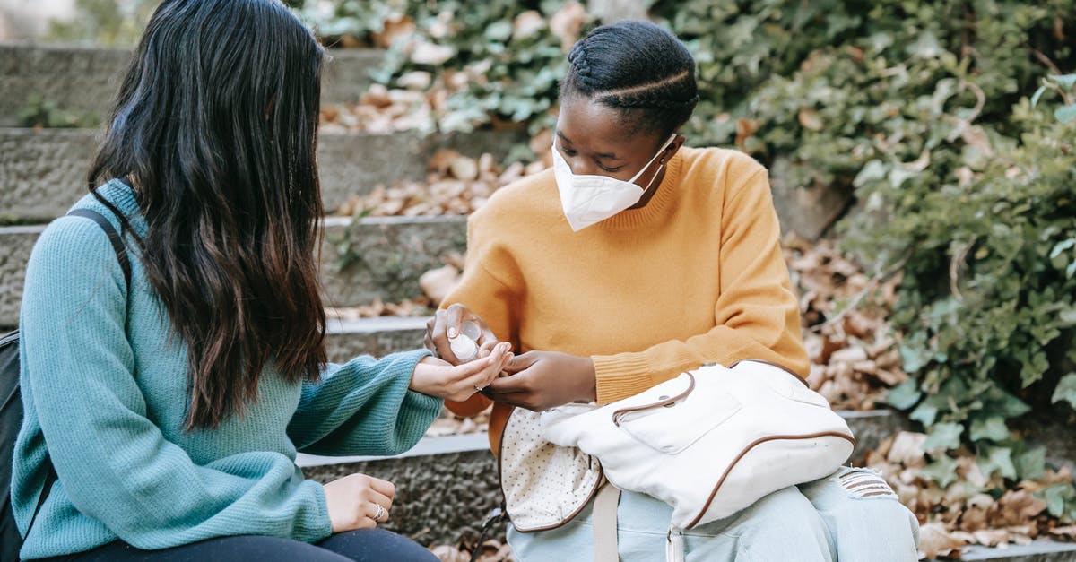 10 year ban after applying for a UK student visa - Unrecognizable ethnic student applying sanitizer on hand of girlfriend outdoors 10 year ban after applying for a UK student visa - Unrecognizable ethnic student applying sanitizer on hand of girlfriend outdoors