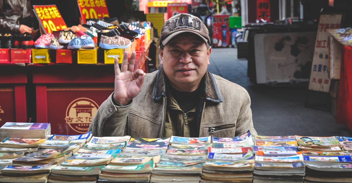 144hr Chinese Exemption - Cruising Tianjin to Shanghai? - Man in Brown Coat in Front of Books 144hr Chinese Exemption - Cruising Tianjin to Shanghai? - Man in Brown Coat in Front of Books