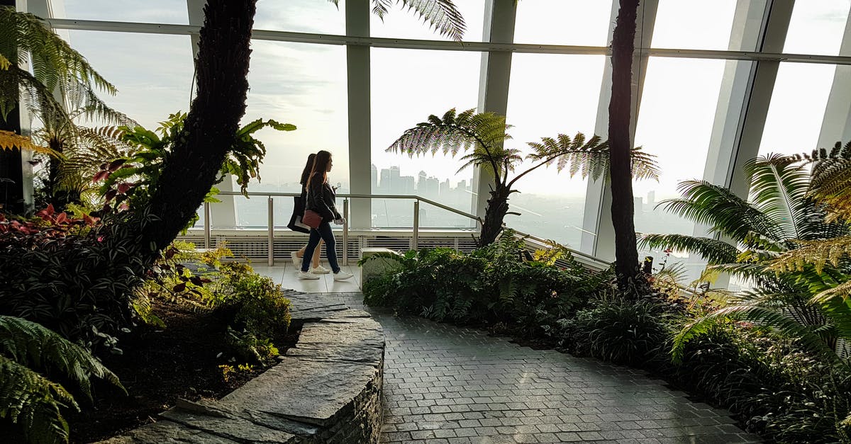 20 hour layover at London Heathrow. Do I need a transit visa to go to a hotel outside airport ? [duplicate] - Two Women Walking Inside a Building With Garden