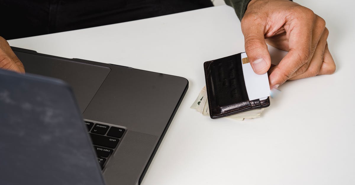2 CharlieCards, 1 Wallet? - Photo Of Person Holding White Card 2 CharlieCards, 1 Wallet? - Photo Of Person Holding White Card
