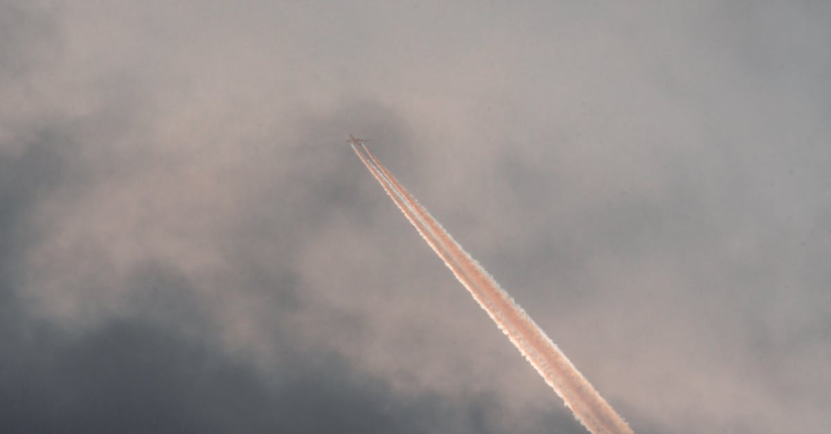 2 hours from central Boulder to flight departure from Denver, feasible? - From below of modern aircraft flying in cloudy sunset sky and leaving straight long track 2 hours from central Boulder to flight departure from Denver, feasible? - From below of modern aircraft flying in cloudy sunset sky and leaving straight long track