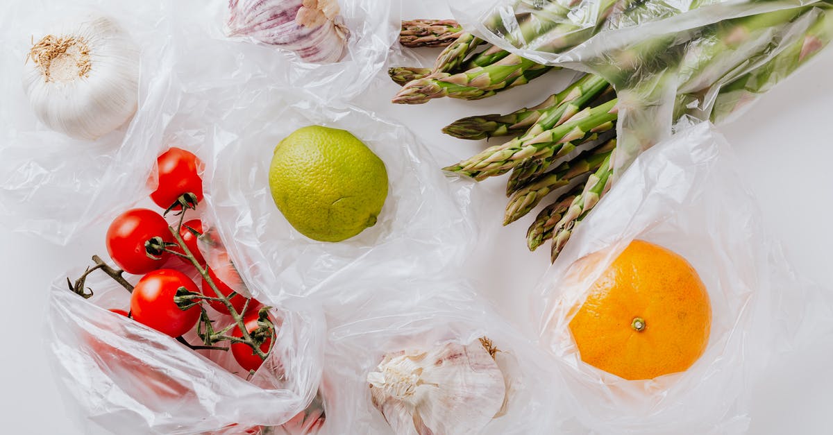2h 15min to change plane & rechecking bag on different tickets in Sydney - Anything to improve my timing? - From above of bunch of tomatoes with raw asparagus put into transparent plastic bags on white table near citrus fruits and garlic bulbs