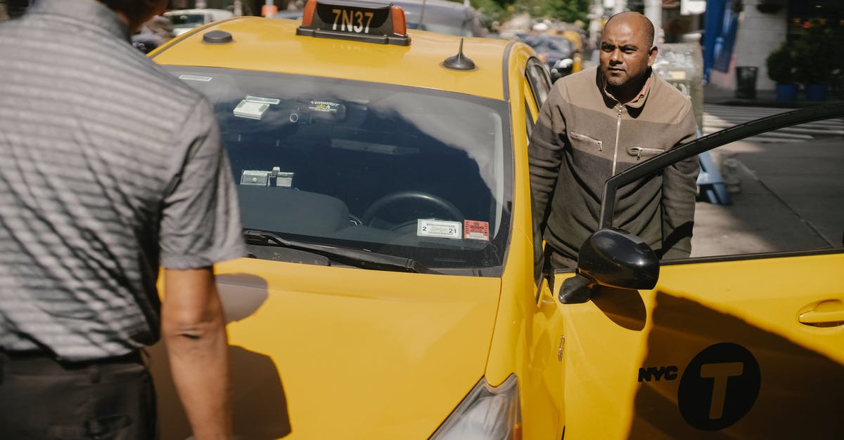 2-hour parking in the US - Serious ethnic cab driver having conversation with man in sunny day in New York 2-hour parking in the US - Serious ethnic cab driver having conversation with man in sunny day in New York