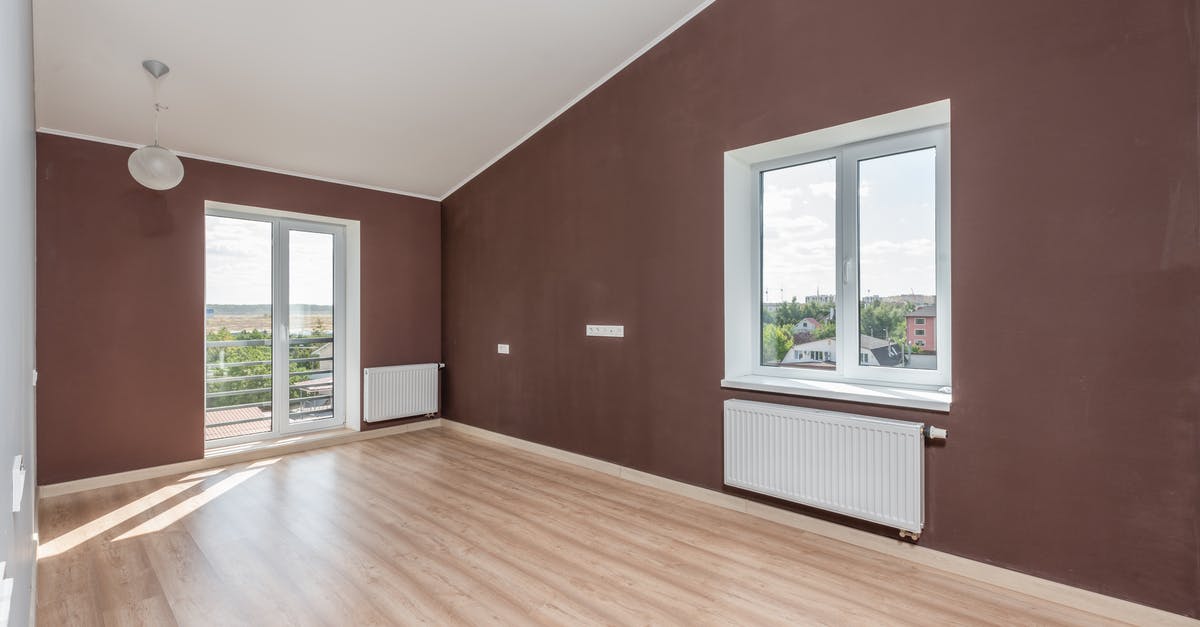 55-floors residential blocks next to the airport - Brown Wooden Parquet Floor Near White Framed Glass Window 55-floors residential blocks next to the airport - Brown Wooden Parquet Floor Near White Framed Glass Window
