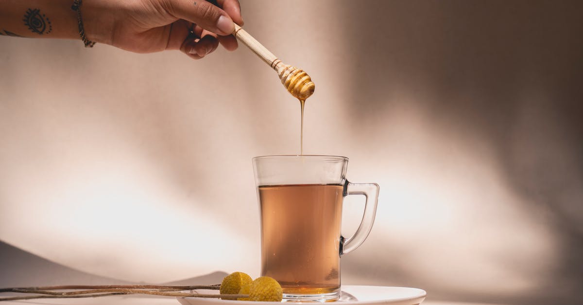 5 kg hard honey in hand luggage? -
A Person Holding a Honey Dipper over a Beverage 5 kg hard honey in hand luggage? -
A Person Holding a Honey Dipper over a Beverage
