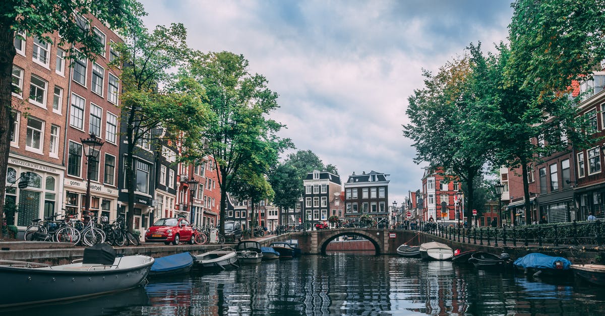 6hour layover in Amsterdam - Photo of Boats Parked on River 6hour layover in Amsterdam - Photo of Boats Parked on River