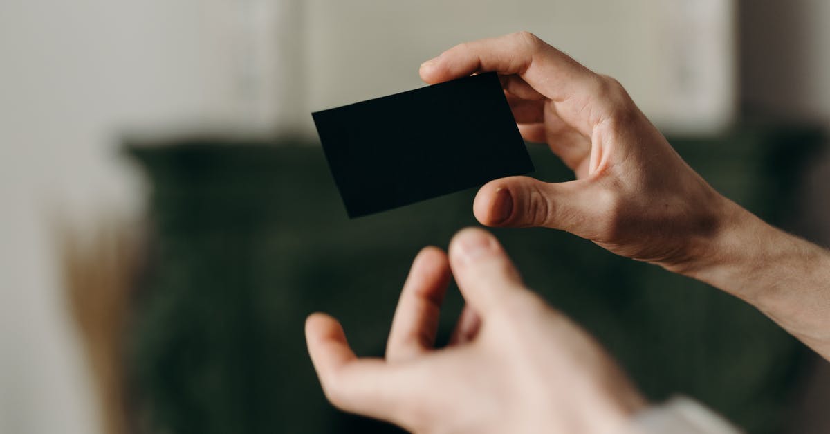 A hotel wants my card details (for payment). Is this safe? [closed] - Person Holding Black Card