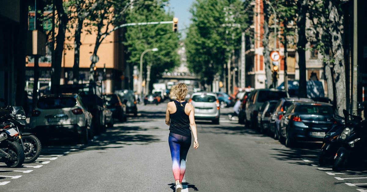 A little problem in European traffic rules: Priority of a car sitting on a "stepstone" island - Woman in Black Tank Top and Blue Denim Jeans Running on Road A little problem in European traffic rules: Priority of a car sitting on a "stepstone" island - Woman in Black Tank Top and Blue Denim Jeans Running on Road