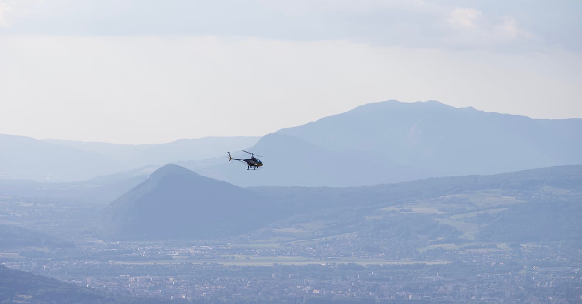 A note on a B1/B2 visa - any obligations to fly directly into the specified city? - Distant helicopter flying over calm sea and coastal city located on shore near hill and mountainous terrain against cloudy sky A note on a B1/B2 visa - any obligations to fly directly into the specified city? - Distant helicopter flying over calm sea and coastal city located on shore near hill and mountainous terrain against cloudy sky