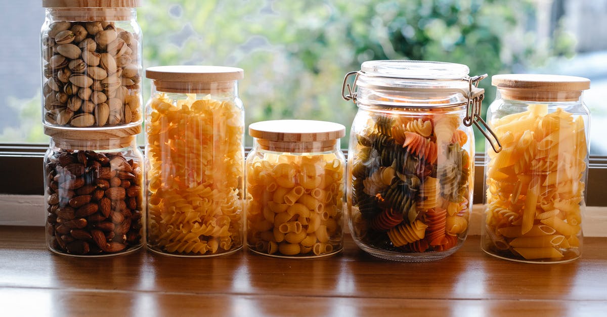 A Sunday in Galway, Ireland. Are many tourist type things closed? - Glass jars filled with assorted types of uncooked pasta and pistachios with almonds placed on wooden table near window in light room A Sunday in Galway, Ireland. Are many tourist type things closed? - Glass jars filled with assorted types of uncooked pasta and pistachios with almonds placed on wooden table near window in light room