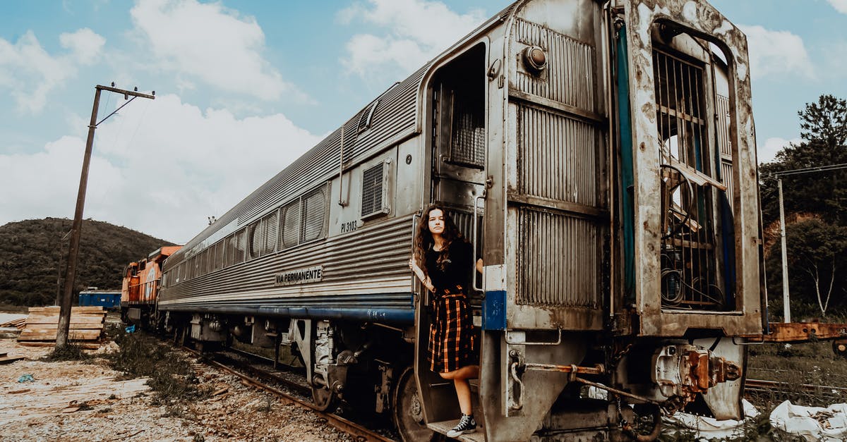 Abandoned railway stations in Japan - Woman in Black Top Standing on Gray and White Train Door Abandoned railway stations in Japan - Woman in Black Top Standing on Gray and White Train Door