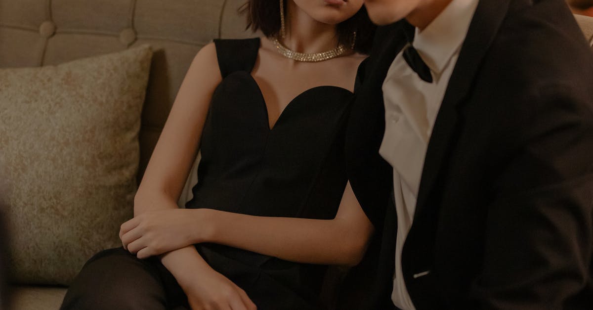 About Dubai, hotel as an unmarried couple but with a twist [duplicate] - Couple Sitting on the Couch