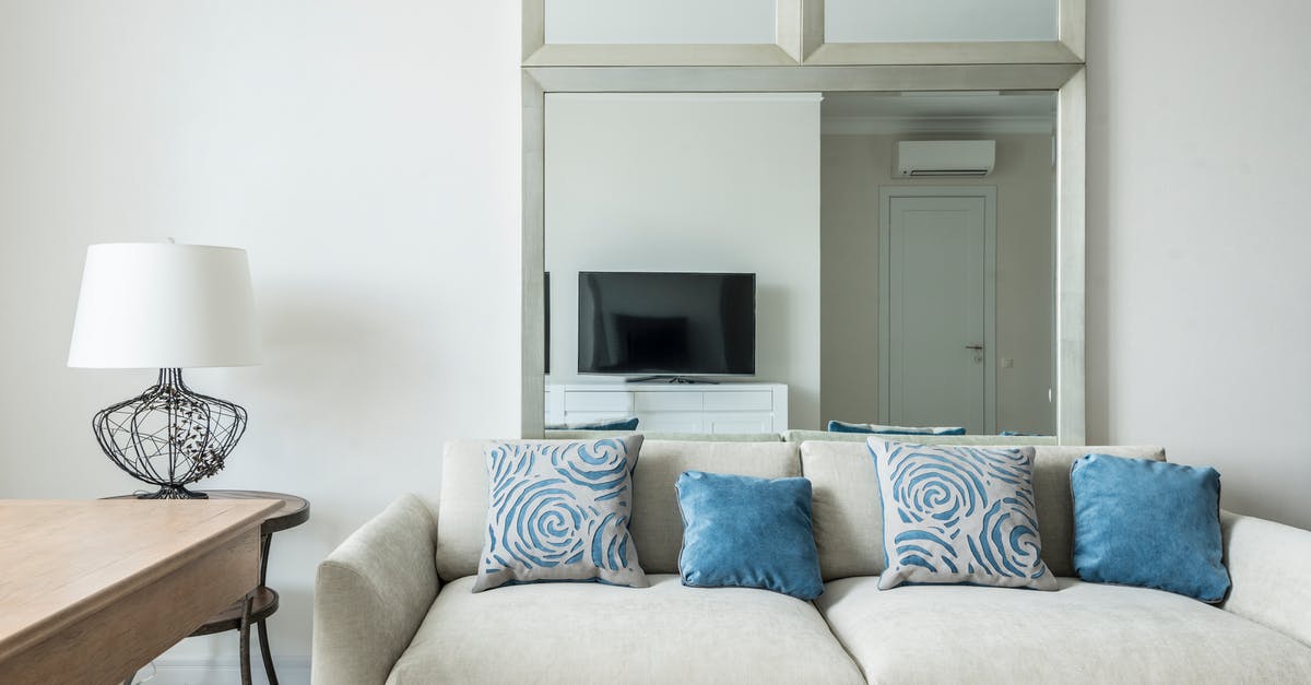Accommodation arrangements when you only have one key - Interior of cozy living room with comfortable sofa with soft cushions placed near table with lamp Accommodation arrangements when you only have one key - Interior of cozy living room with comfortable sofa with soft cushions placed near table with lamp