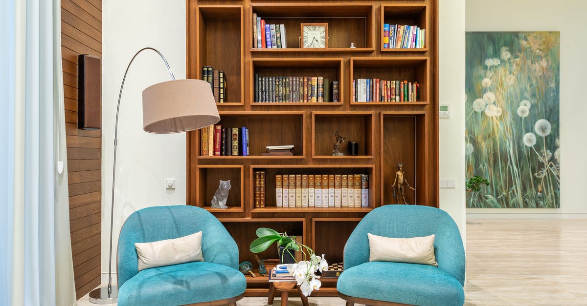 Accommodation details for booked tour while applying for a visa - Living room with cozy chairs near lamp and wooden bookcase Accommodation details for booked tour while applying for a visa - Living room with cozy chairs near lamp and wooden bookcase