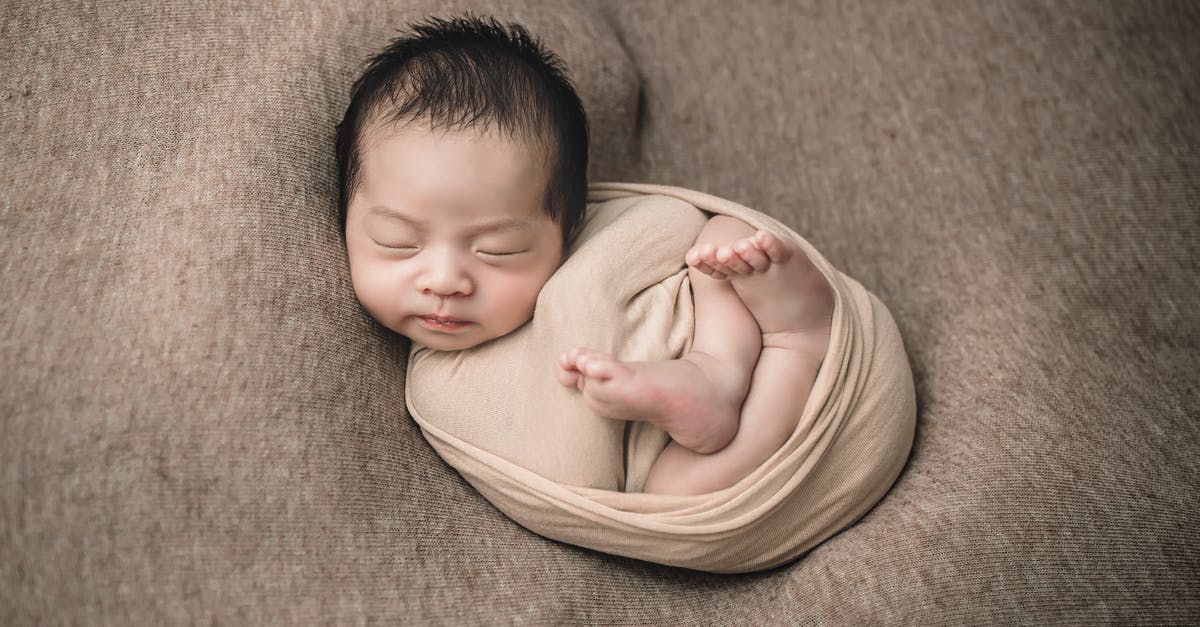 Adding a newborn child to US tourist visa (B1/B2) - Baby in Yellow Shirt Lying on Brown Textile Adding a newborn child to US tourist visa (B1/B2) - Baby in Yellow Shirt Lying on Brown Textile