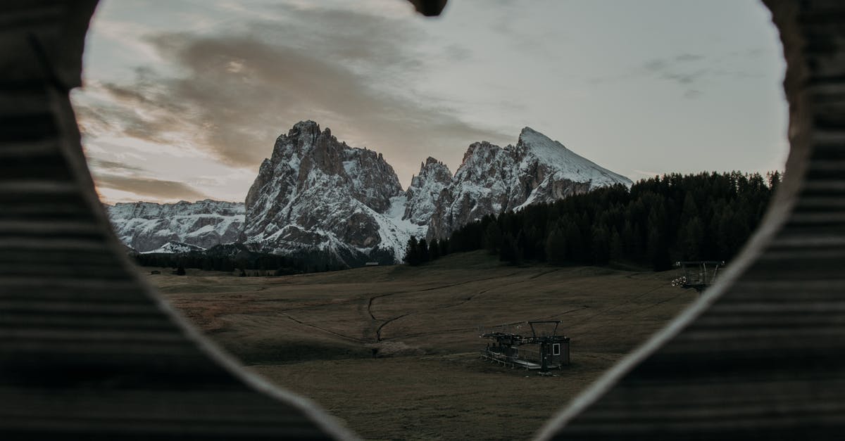 Address in Nepal field in visa application form - Through heart shaped hole of wooden fence on rocky cliffs covered with snow located on grassy field in rural area Address in Nepal field in visa application form - Through heart shaped hole of wooden fence on rocky cliffs covered with snow located on grassy field in rural area
