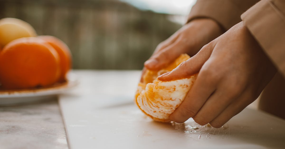 Advantages or disadvantages of triple citizenship? [closed] - A Person in Brown Long Sleeve Holding Orange Fruit