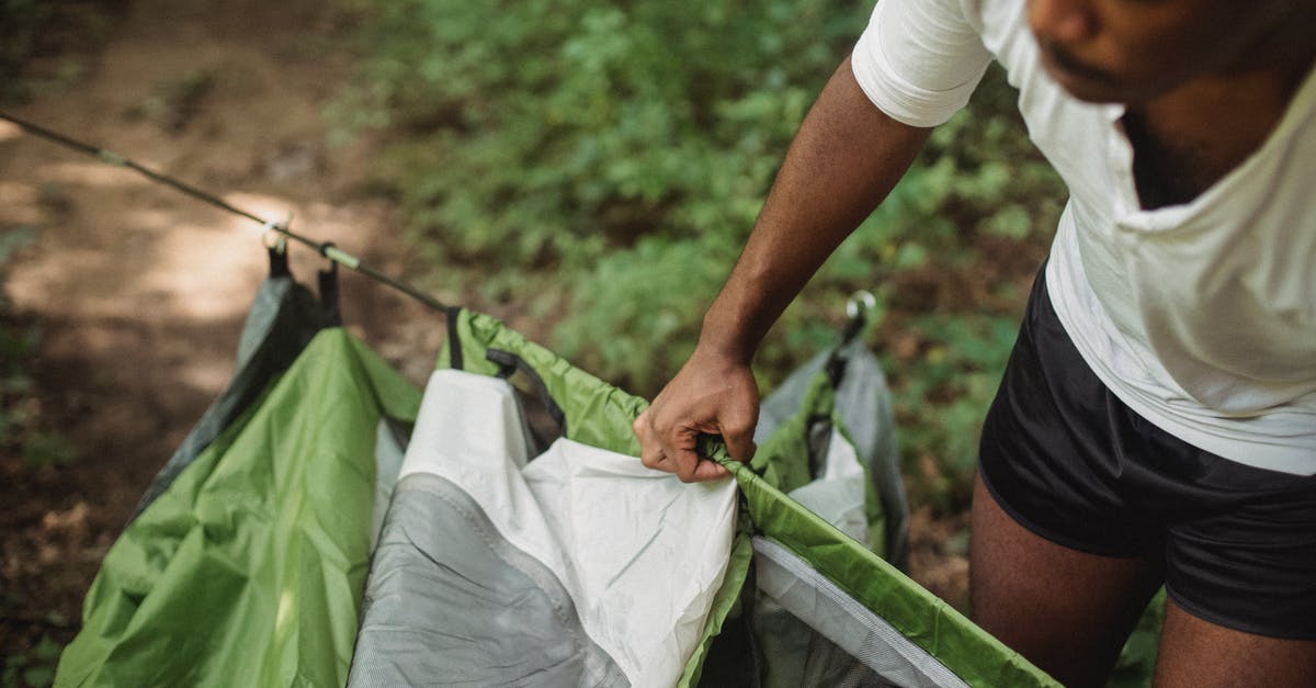 Adventure Travel: Where should I go in India to experience staying in a forest? [closed] - From above of crop African American male tourist preparing for camping in forest while traveling in wildlife