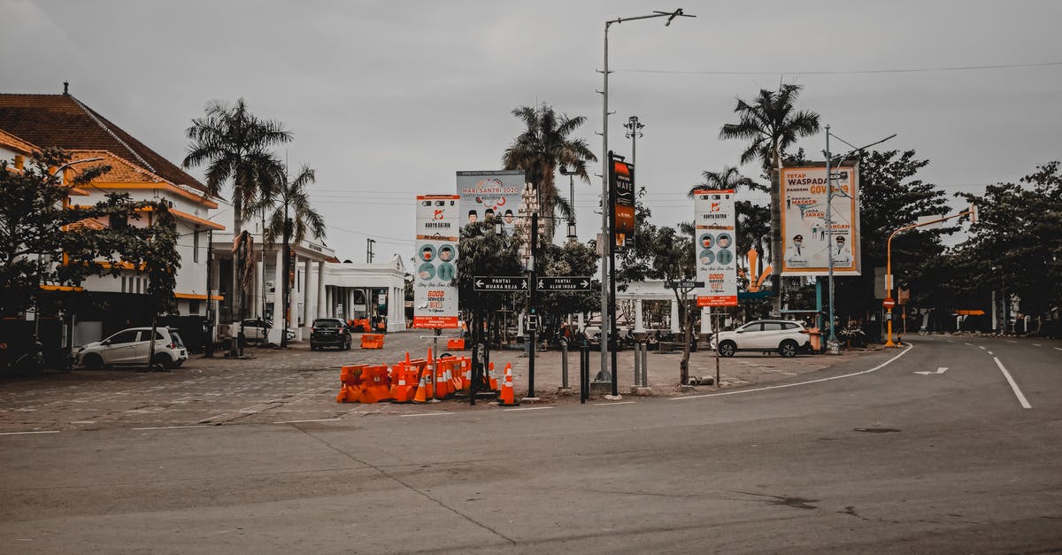 Affordable and accessible accommodation options with car parking near Paris? - Asphalt road with parked cars near houses and tree palms Affordable and accessible accommodation options with car parking near Paris? - Asphalt road with parked cars near houses and tree palms