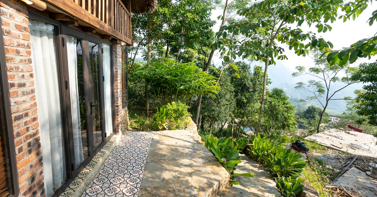 after German residence permit expires, can I start my tourist 90/180 days? [duplicate] - Exterior of house with outdoor stone stairs located on top of hill in tropical resort