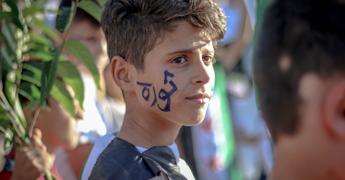 After Syria entered civil war, did B1/B2 or Schengen visas of Syrians became useless? - Side view of ethnic teenage boy with Arabic inscription on face standing on crowded street at protest movement against state policy After Syria entered civil war, did B1/B2 or Schengen visas of Syrians became useless? - Side view of ethnic teenage boy with Arabic inscription on face standing on crowded street at protest movement against state policy