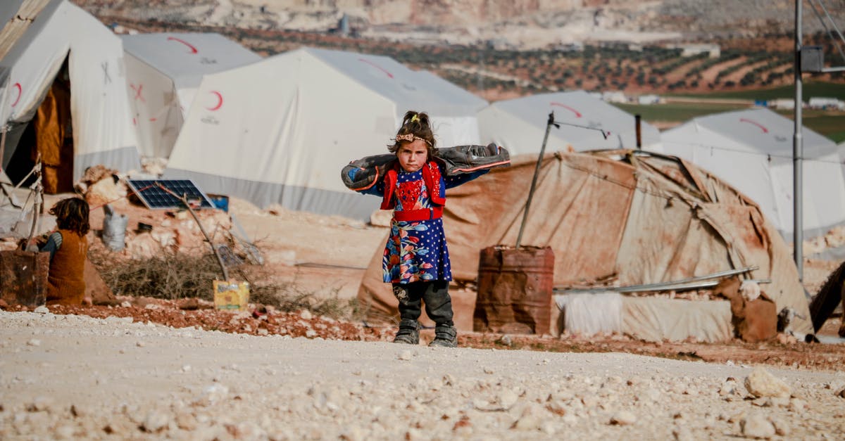 After Syria entered civil war, did B1/B2 or Schengen visas of Syrians became useless? - Ethnic girl standing near refugee tents After Syria entered civil war, did B1/B2 or Schengen visas of Syrians became useless? - Ethnic girl standing near refugee tents