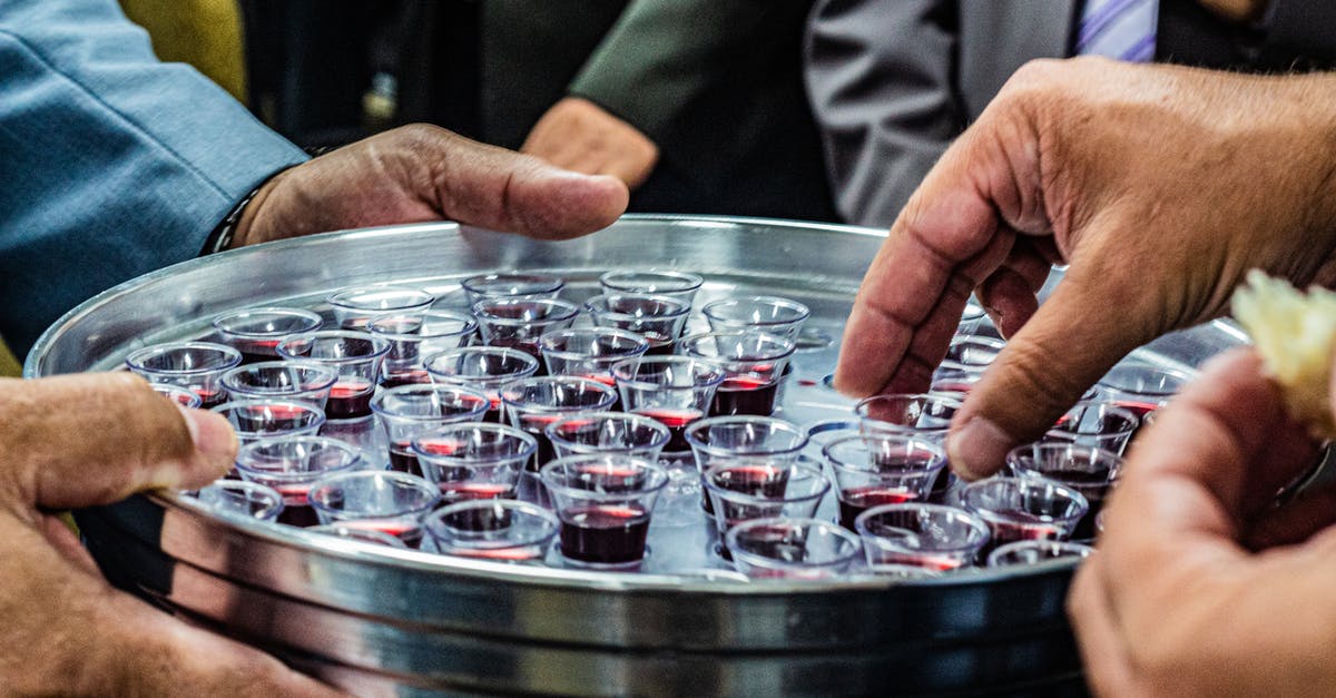 Airport security compatible container for small amounts of alcoholic spirits (drinks)? - Crop anonymous male with metal tray full of small glasses of red wine for degustation Airport security compatible container for small amounts of alcoholic spirits (drinks)? - Crop anonymous male with metal tray full of small glasses of red wine for degustation