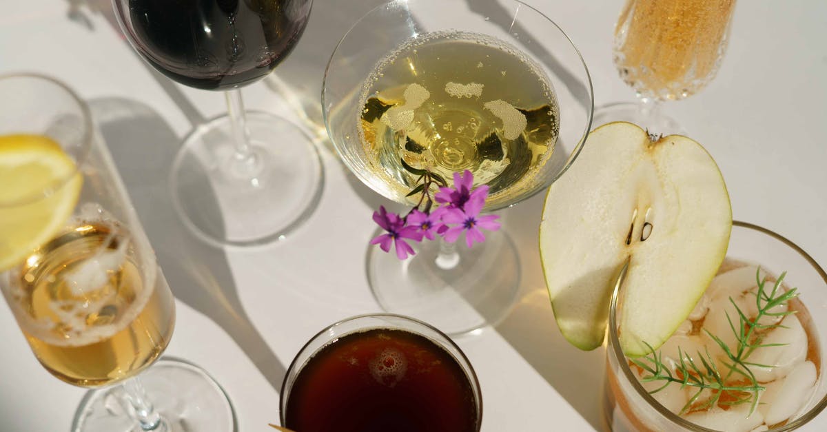 Alcohol when flying to Singapore from EU through Malaysia - Glasses of cocktails decorated with pear and blooming flowers Alcohol when flying to Singapore from EU through Malaysia - Glasses of cocktails decorated with pear and blooming flowers