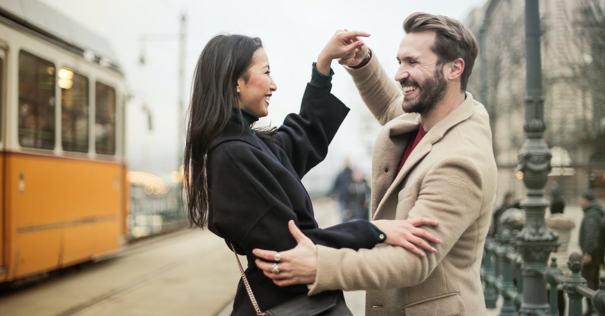 Almaty to Urumqi by connecting train (via Altynkol and Khorgas) - A Happy Couple Dancing On Sidewalk Almaty to Urumqi by connecting train (via Altynkol and Khorgas) - A Happy Couple Dancing On Sidewalk