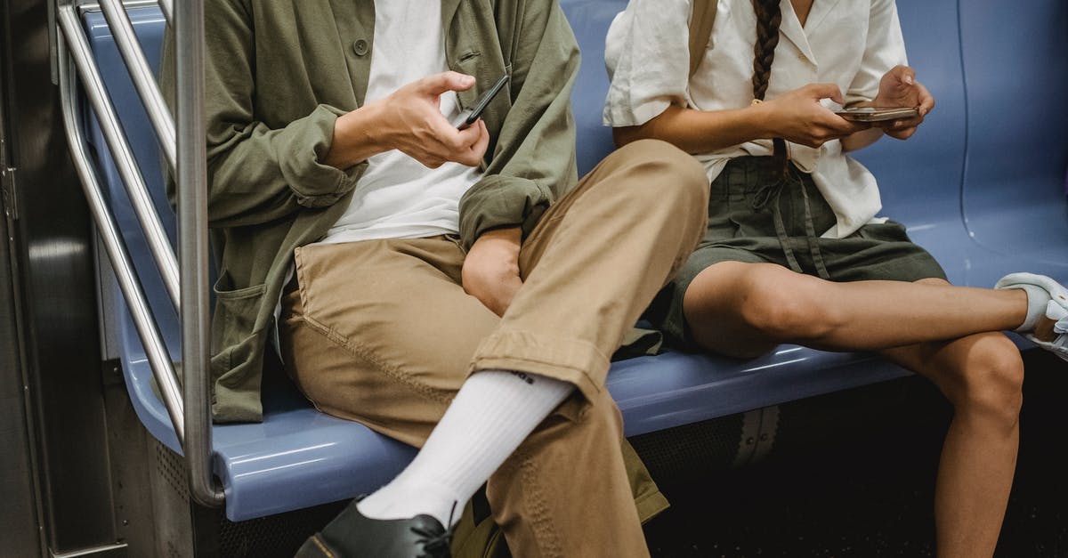 Almaty to Urumqi by connecting train (via Altynkol and Khorgas) - Crop couple browsing smartphones in subway carriage Almaty to Urumqi by connecting train (via Altynkol and Khorgas) - Crop couple browsing smartphones in subway carriage