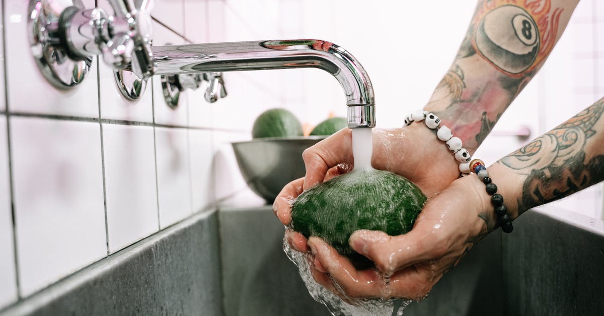Alternative to public hot water bath in Japan for a tattooed person - Person Holding Green Powder in Stainless Steel Faucet Alternative to public hot water bath in Japan for a tattooed person - Person Holding Green Powder in Stainless Steel Faucet
