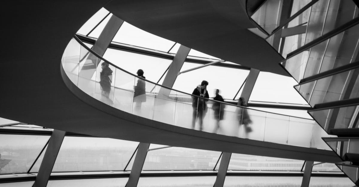 American overstay in Germany - People Going Up on the Escalator in the Reichstag Dome, Berlin, Germany American overstay in Germany - People Going Up on the Escalator in the Reichstag Dome, Berlin, Germany