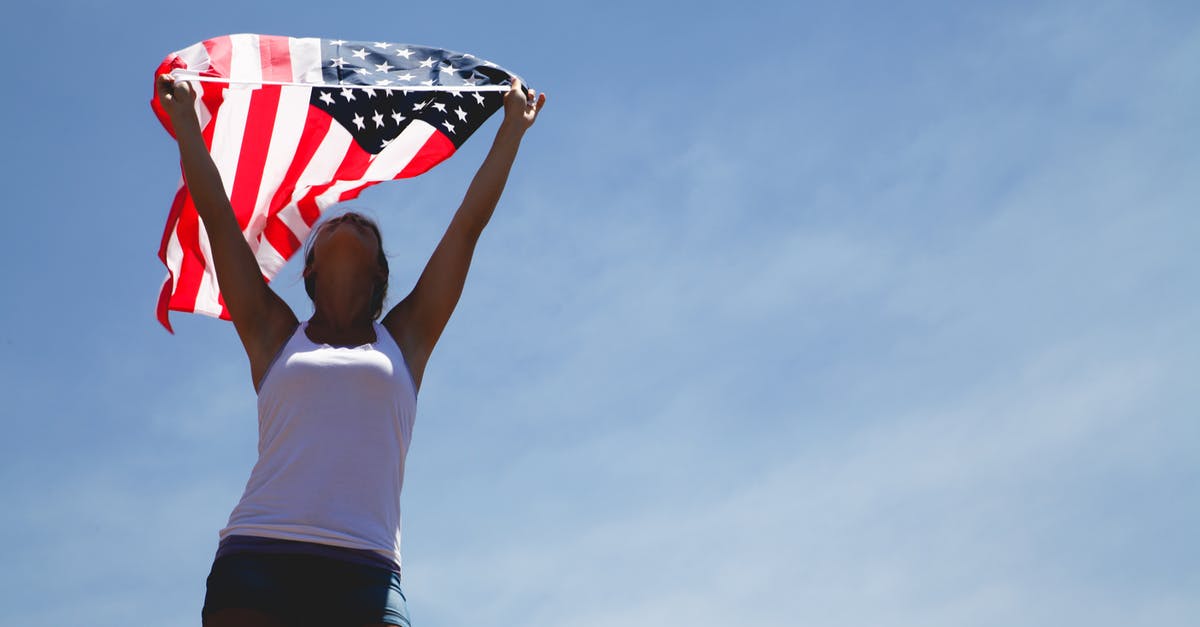 American woman getting Saudi visa in Abu Dhabi - Woman Holding Us Flag during Daytime American woman getting Saudi visa in Abu Dhabi - Woman Holding Us Flag during Daytime