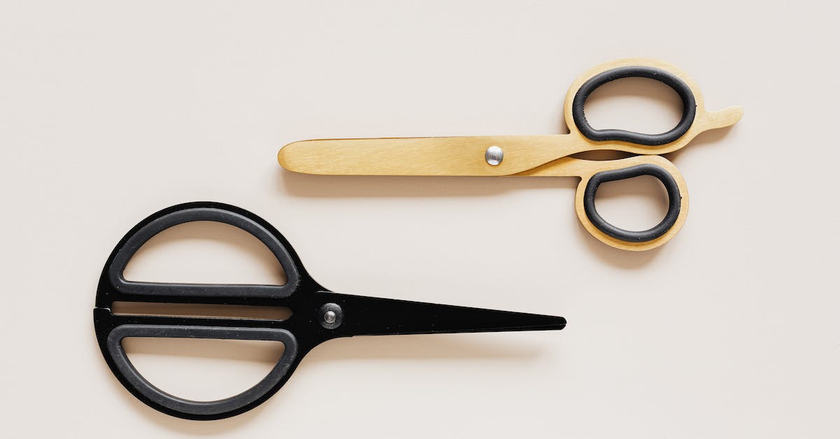 Amtrak "large sharp objects" restriction: Are small knives included? - Top view of multicolored scissors of different shape on beige table Amtrak "large sharp objects" restriction: Are small knives included? - Top view of multicolored scissors of different shape on beige table