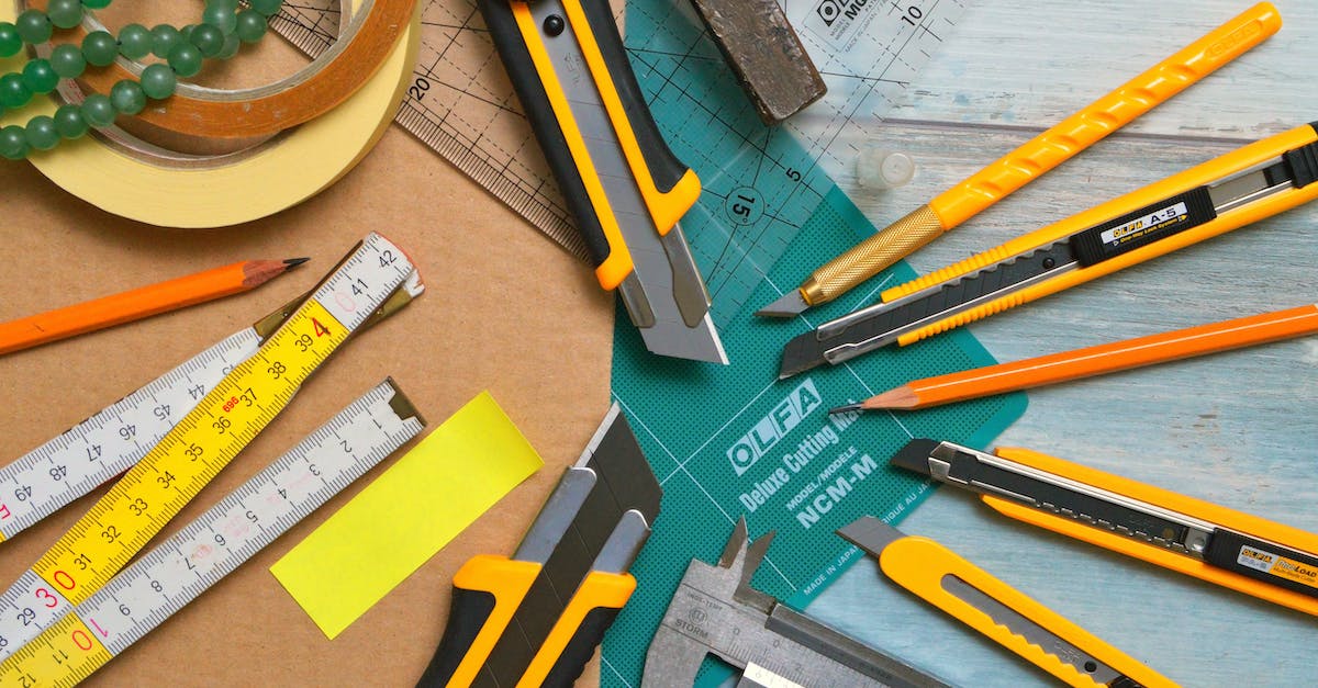 Amtrak "large sharp objects" restriction: Are small knives included? - Assorted-type-and-size Utility Cutters on Clear and Green Olfa Measuring Tool Near Adhesive Tape Rolls Amtrak "large sharp objects" restriction: Are small knives included? - Assorted-type-and-size Utility Cutters on Clear and Green Olfa Measuring Tool Near Adhesive Tape Rolls