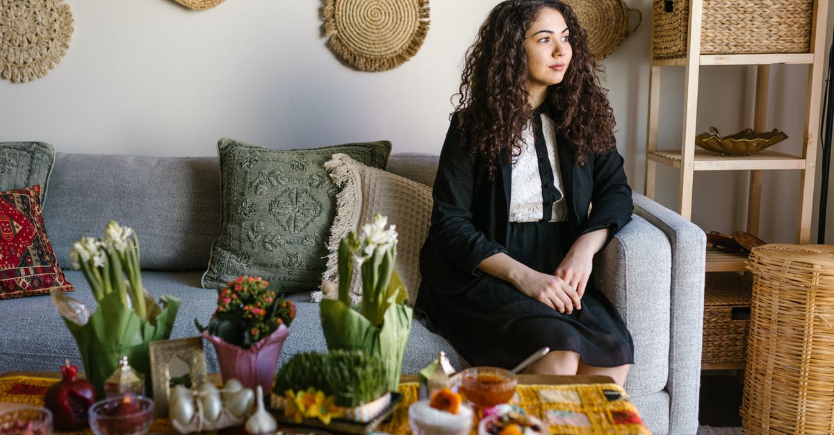 An authentic way to celebrate Novruz in Azerbaijan - Woman Sitting On A Couch Beside Table With Traditional Food An authentic way to celebrate Novruz in Azerbaijan - Woman Sitting On A Couch Beside Table With Traditional Food