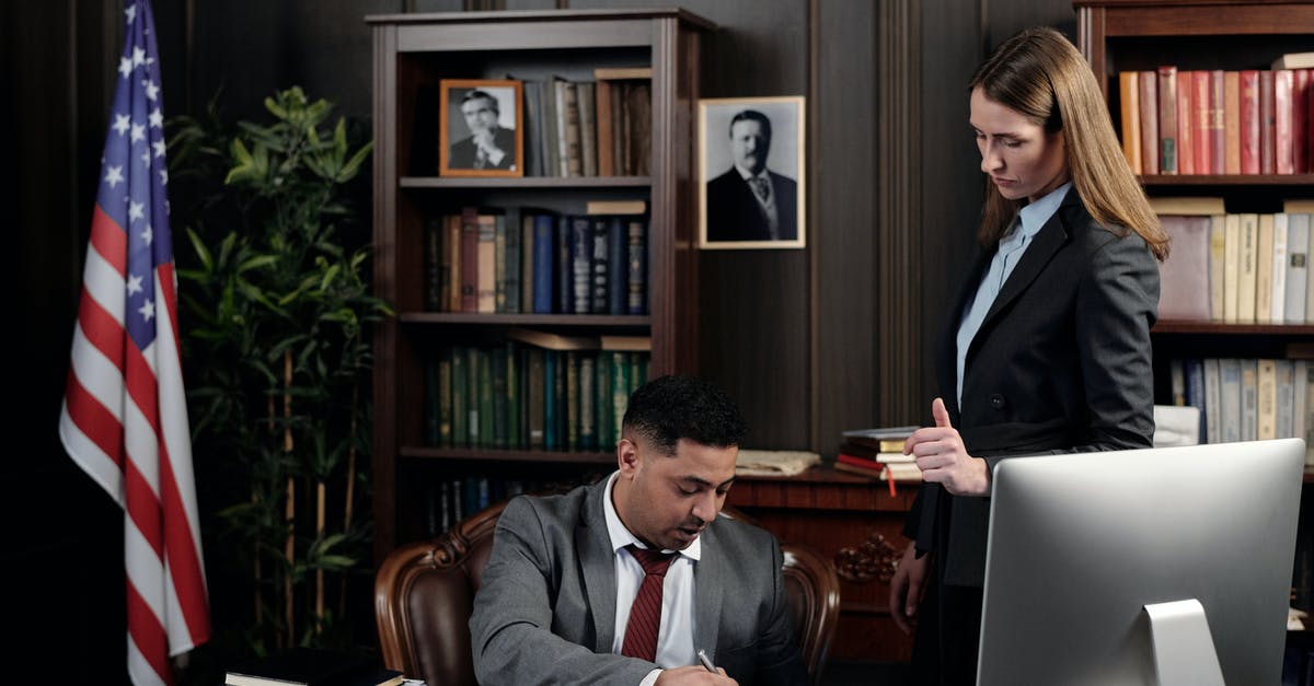 Any documents to show when entering USA with ESTA? - Lawyers in an Office Looking at Documents Any documents to show when entering USA with ESTA? - Lawyers in an Office Looking at Documents