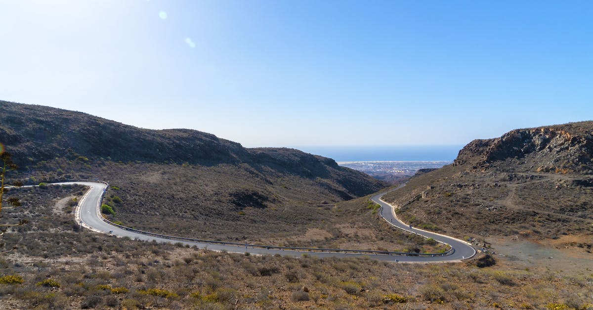 Any special requirements in driving from Spain to France? - Gray Asphalt Road Between Green Grass Covered Mountains Under Blue Sky Any special requirements in driving from Spain to France? - Gray Asphalt Road Between Green Grass Covered Mountains Under Blue Sky