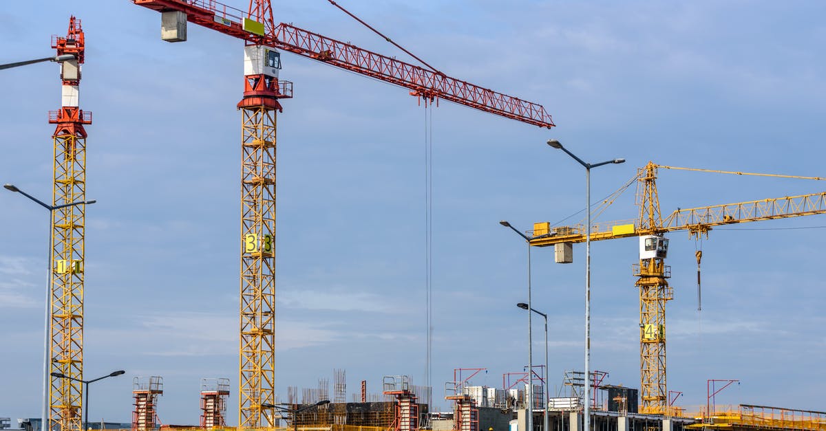 Apply for ESTA if you work for a US company as a contractor - Three Yellow and Red Tower Cranes Under Clear Blue Sky Apply for ESTA if you work for a US company as a contractor - Three Yellow and Red Tower Cranes Under Clear Blue Sky