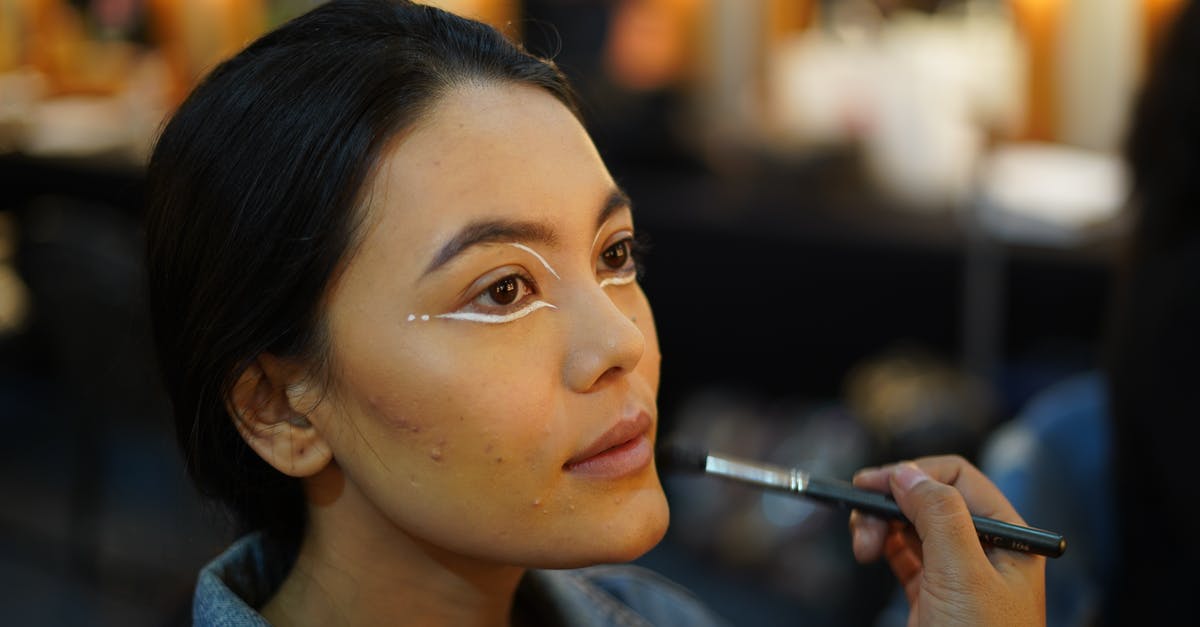 Apply for India visa but not effective immediately - Crop visagiste applying makeup on face of woman Apply for India visa but not effective immediately - Crop visagiste applying makeup on face of woman