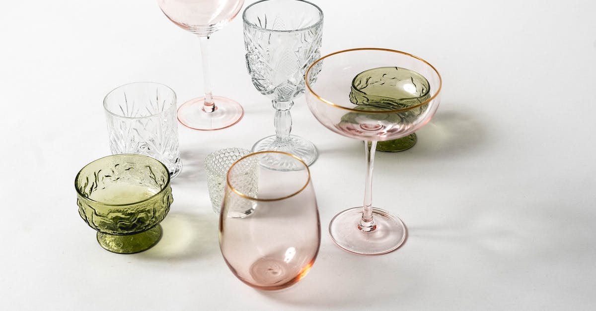 Applying for new B1/B2 visa with new passport, the birthday on my new is different from my old - From above collection of various colorful glasses for different drinks with different shapes placed on white background in light studio