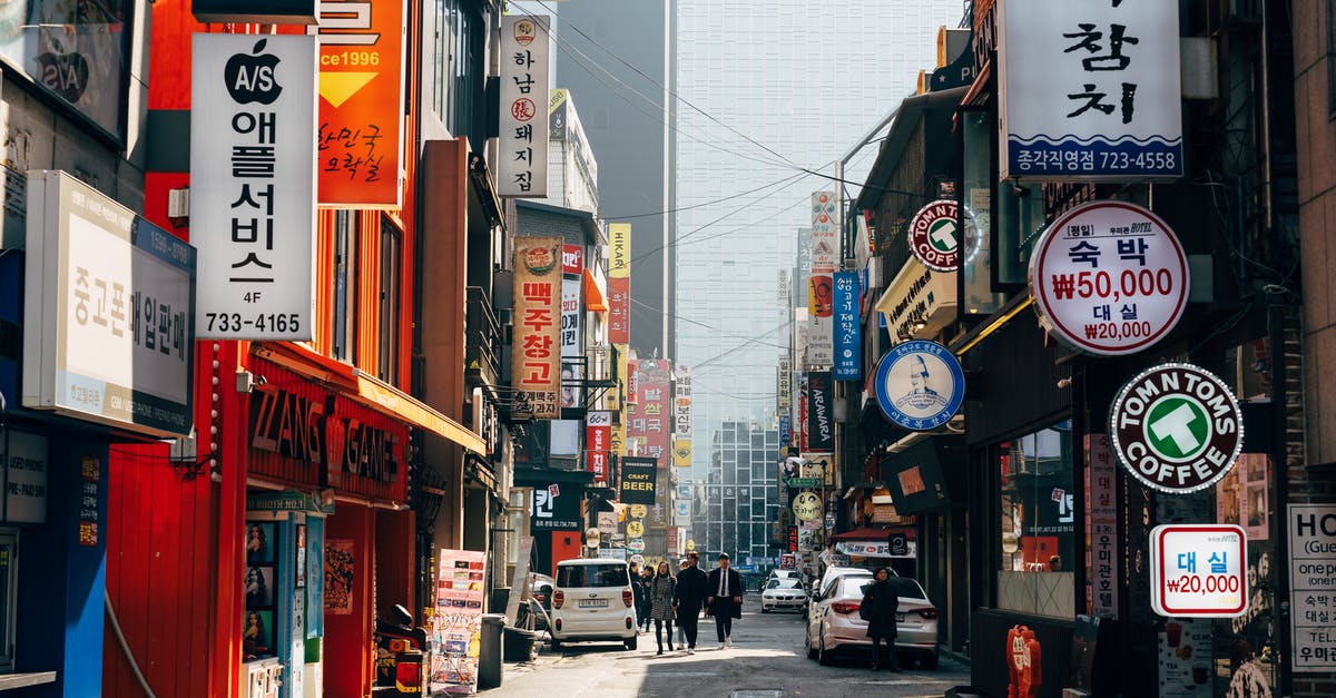 Applying for South Korean tourist visas - People Walking on Sidewalk Near Buildings Applying for South Korean tourist visas - People Walking on Sidewalk Near Buildings