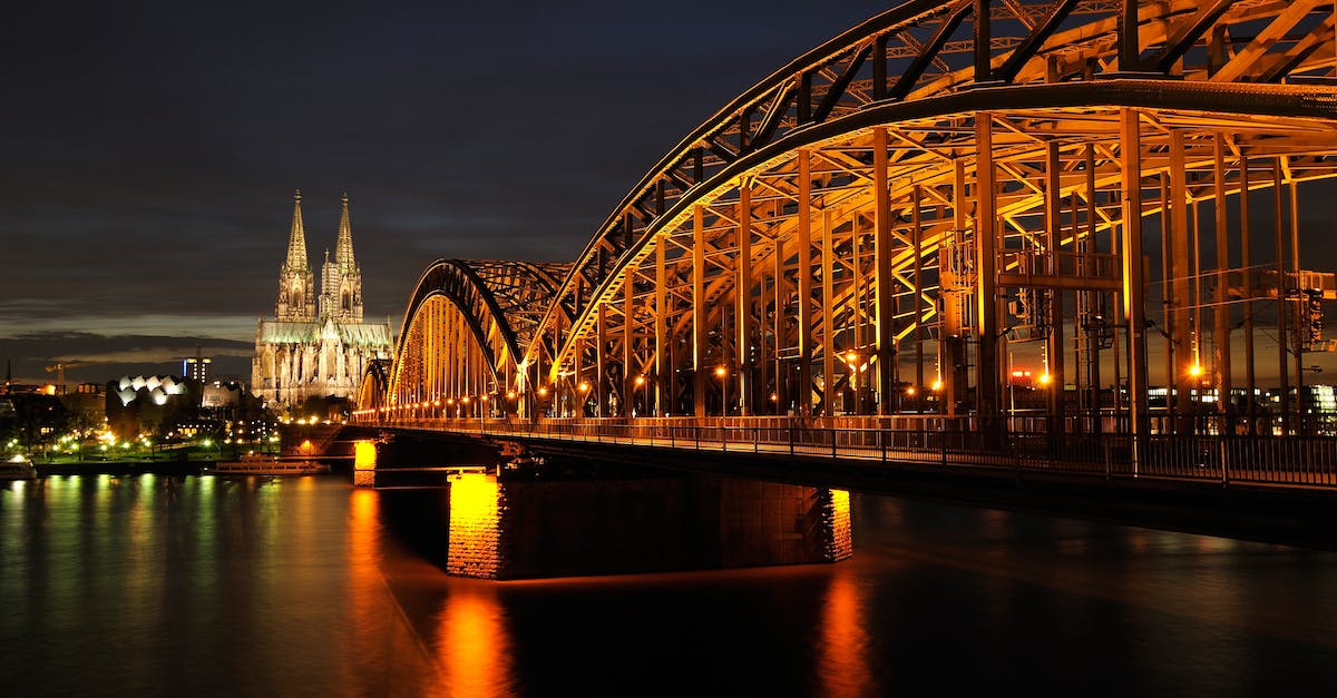 Approx how long will it take to go to Cologne Bonn Airport from Cologne city center? - Architectural Photo of Bridge during Nighttime Approx how long will it take to go to Cologne Bonn Airport from Cologne city center? - Architectural Photo of Bridge during Nighttime