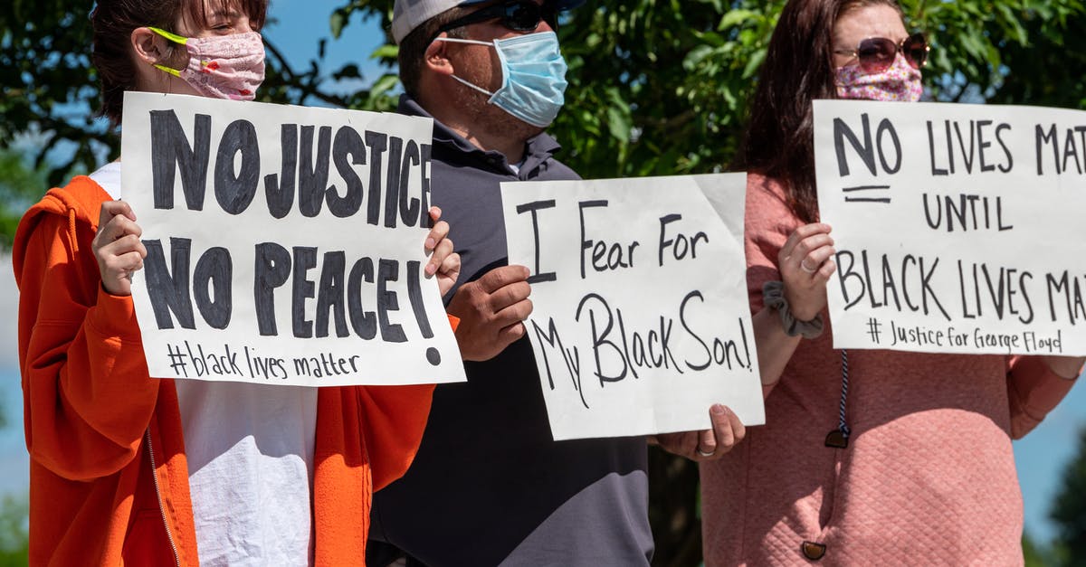 Are airlines discounting to boost demand during pandemic? - Multiethnic rebels in casual wear and medical masks standing with banners in city park while attending antiracist meeting Are airlines discounting to boost demand during pandemic? - Multiethnic rebels in casual wear and medical masks standing with banners in city park while attending antiracist meeting
