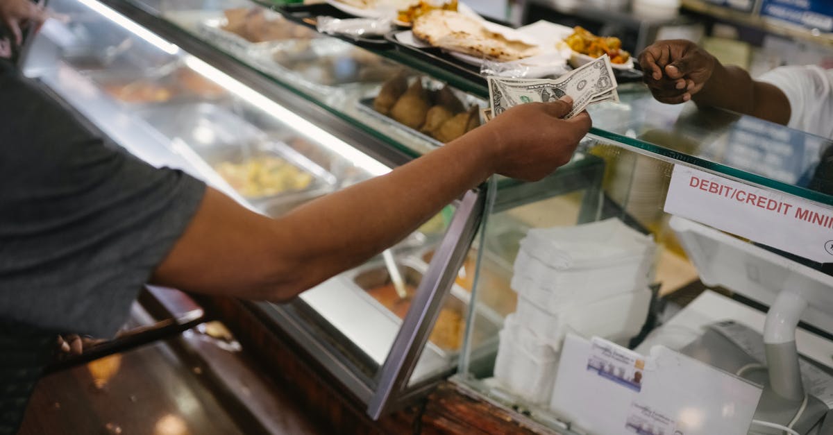 Are customs liable if they break something doing their job? - Crop faceless person standing near checkout buying food and passes money for dinner in cafe Are customs liable if they break something doing their job? - Crop faceless person standing near checkout buying food and passes money for dinner in cafe