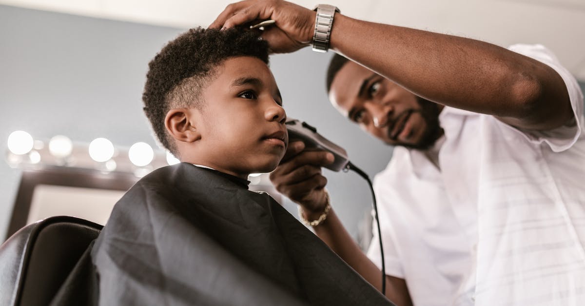 Are electric hair straighteners allowed on flights? - Man in White Dress Shirt Using Electric Razor Are electric hair straighteners allowed on flights? - Man in White Dress Shirt Using Electric Razor