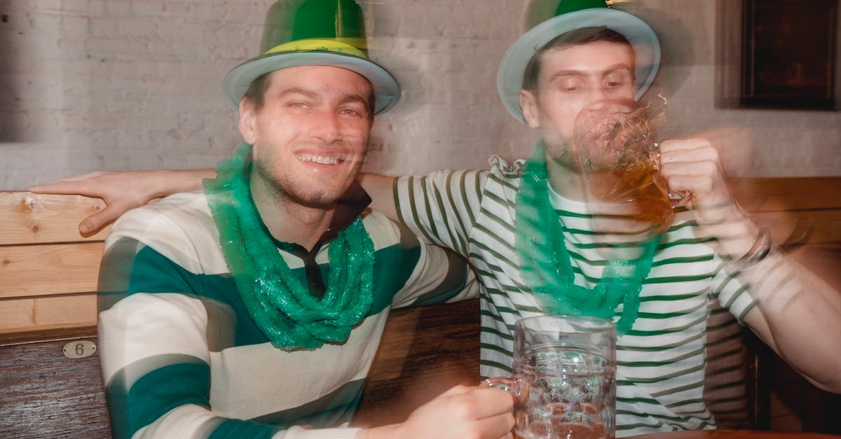 Are feathers in my hat allowed through UK & Irish customs? - Through glass wall view of smiling man against partner enjoying beer from jar mugs at table during Feast of Saint Patrick in bar Are feathers in my hat allowed through UK & Irish customs? - Through glass wall view of smiling man against partner enjoying beer from jar mugs at table during Feast of Saint Patrick in bar