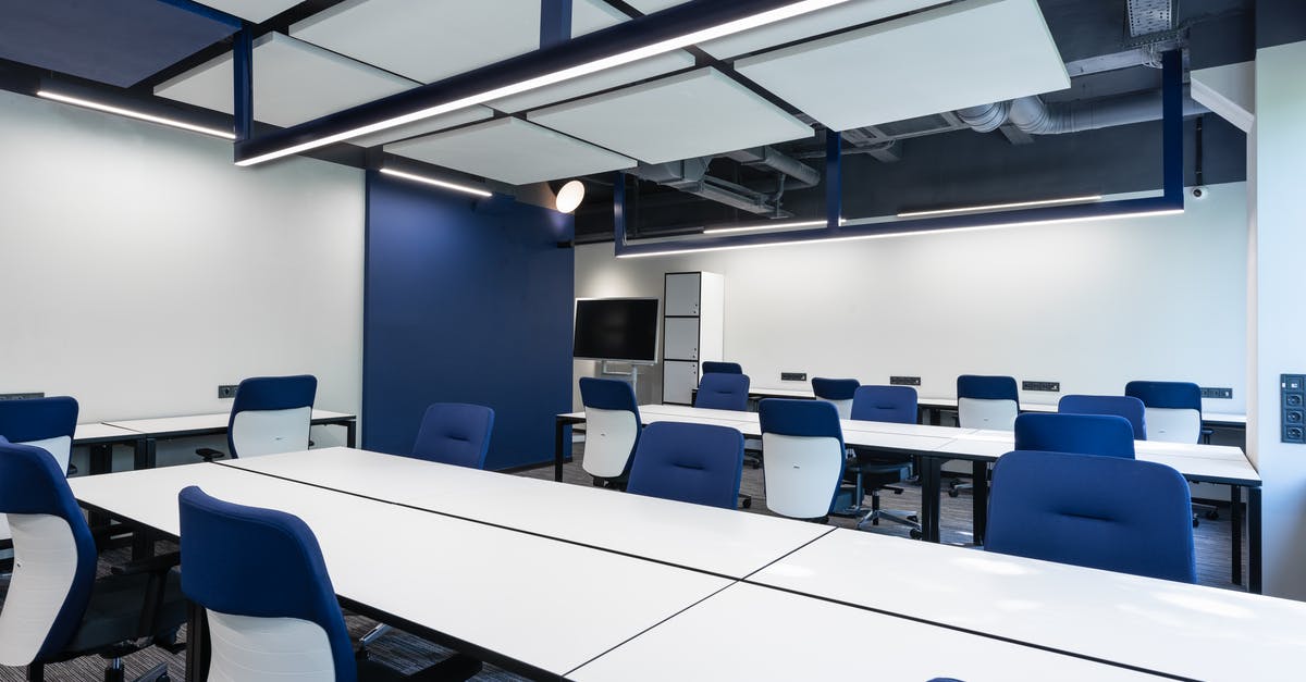 Are French beaches open for the public in general? - Interior of modern spacious workspace with long white tables and blue armchairs placed near monitor with black screen in business center Are French beaches open for the public in general? - Interior of modern spacious workspace with long white tables and blue armchairs placed near monitor with black screen in business center