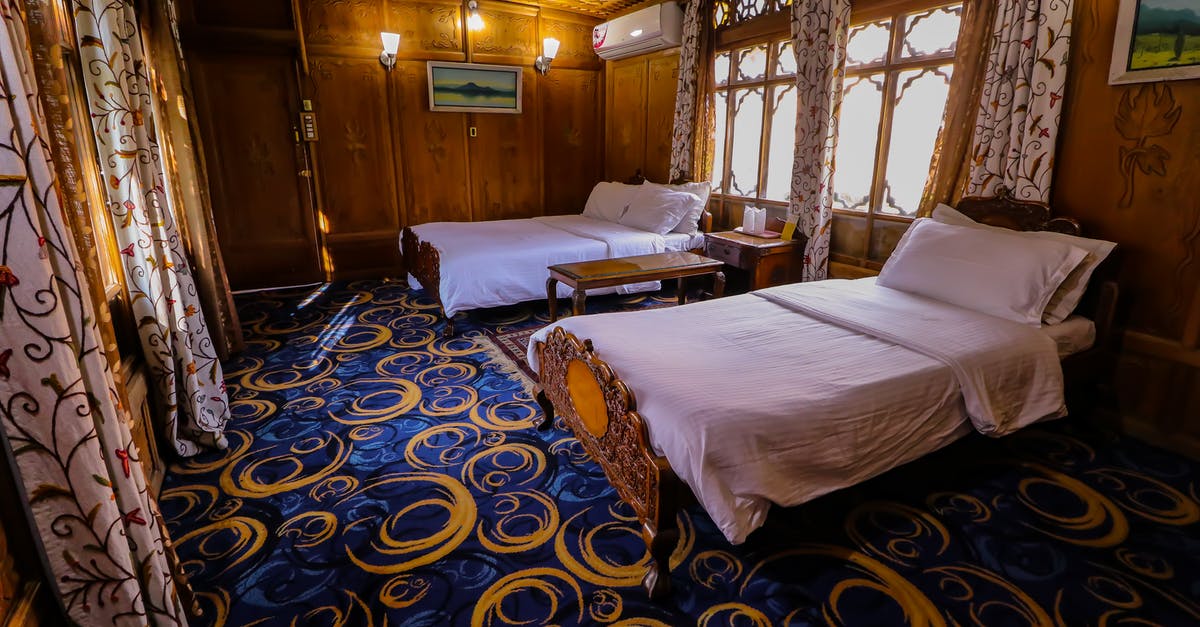 Are hotel beds rated? - Two Double Beds in the Room with Blue Carpet and Wooden Walls Are hotel beds rated? - Two Double Beds in the Room with Blue Carpet and Wooden Walls