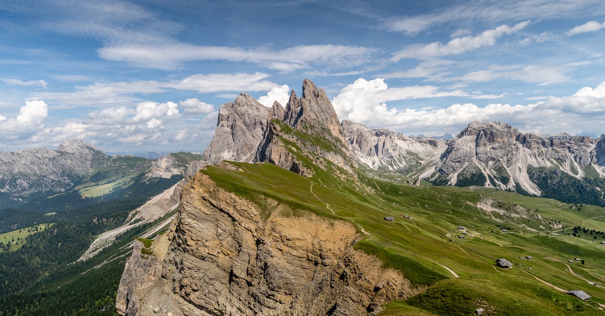 Are Italian Dolomites different in landscape and experience compared to Austrian Tyrol region? - Green Grass Field and Rocky Mountains Under Blue Sky Are Italian Dolomites different in landscape and experience compared to Austrian Tyrol region? - Green Grass Field and Rocky Mountains Under Blue Sky